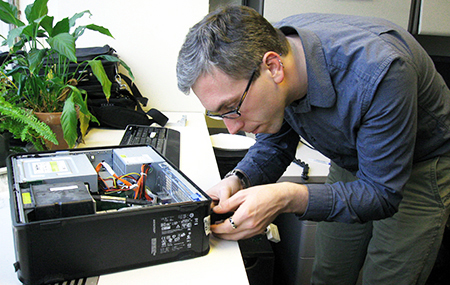 DITR consultant fixing a desktop computer