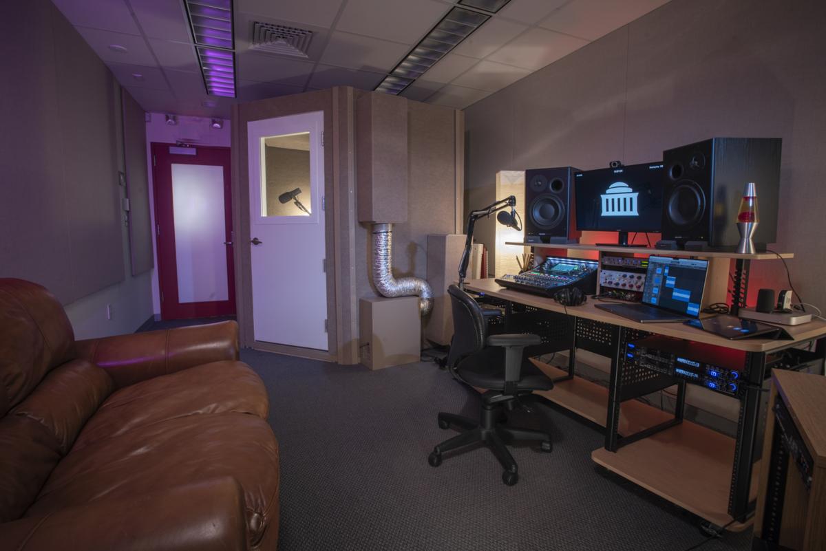 View of production studio showing control desk and couch