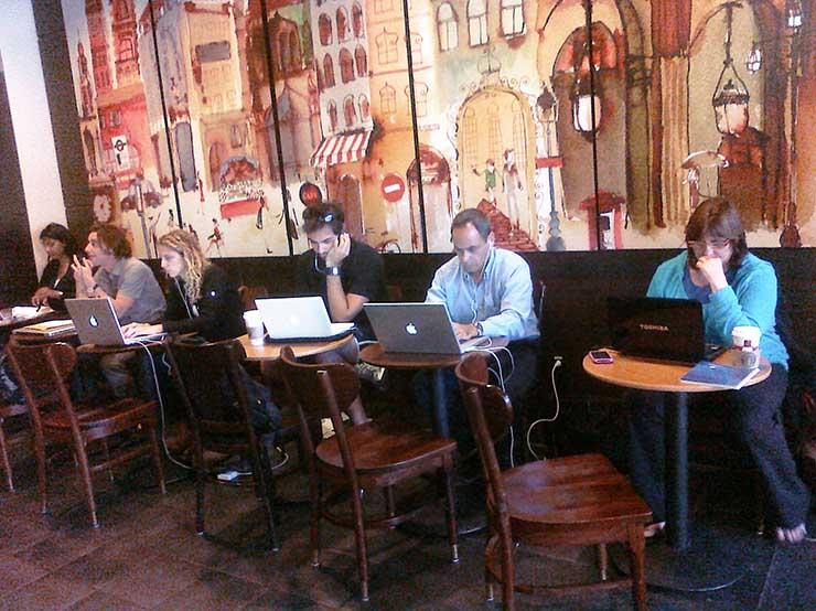 People working on laptops at a coffee shop